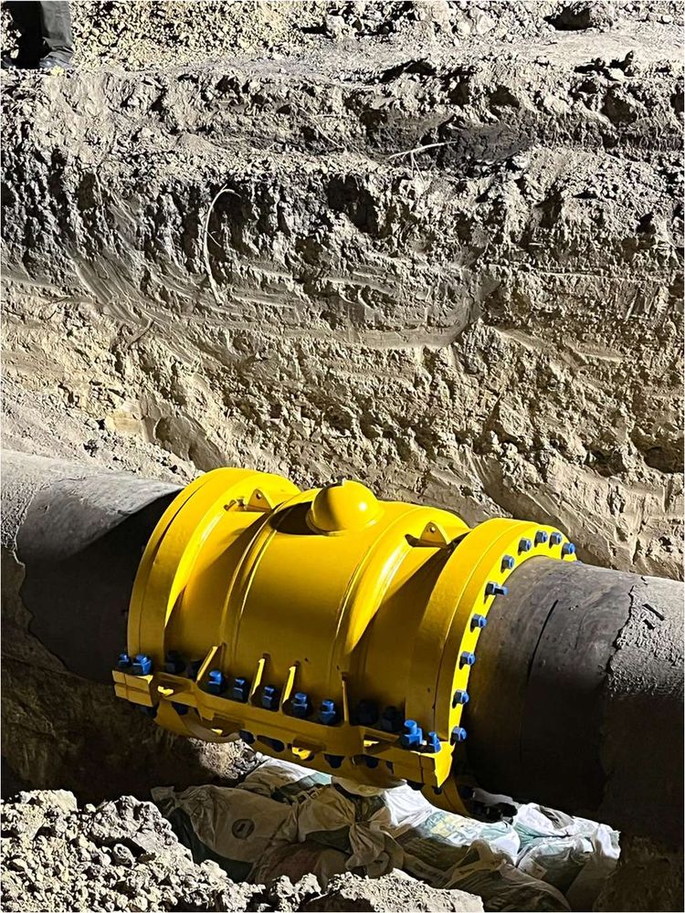 Bolted mechanical pipeline repair clamp installed on a buried steel pipeline